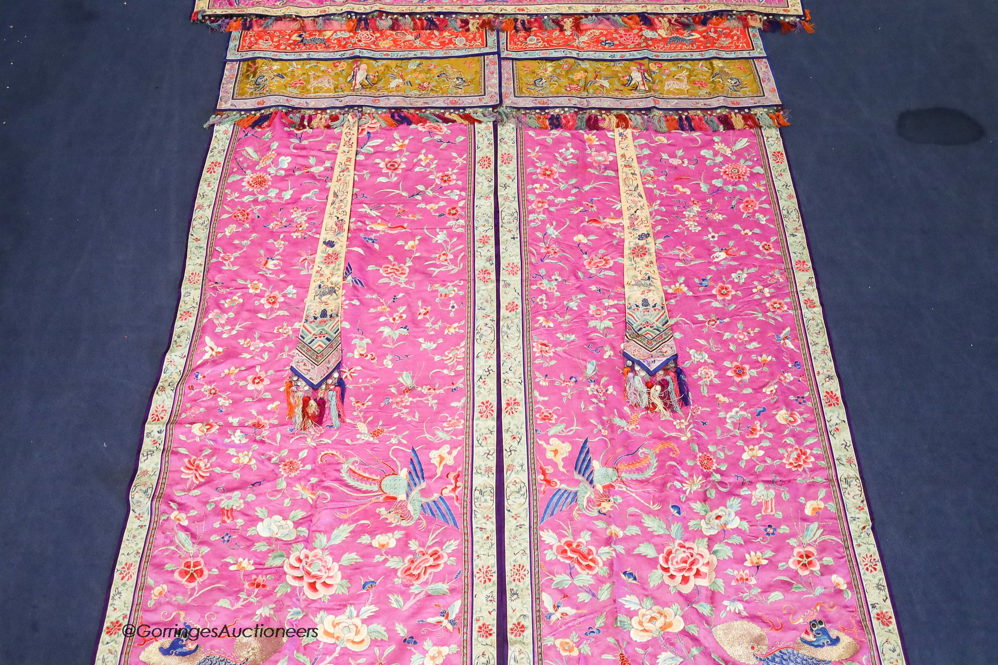 A pair of 20th century Chinese silk embroidered ceremonial panels, possibly for a wedding, 228cm not including fringing, each panel width 80cm, with a matching pelmet, width 198cm